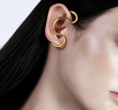 Gold ear cuff around the ear