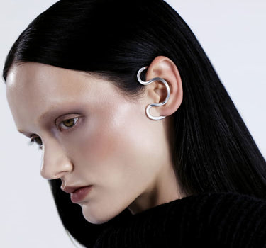 Silver ear cuff around the ear